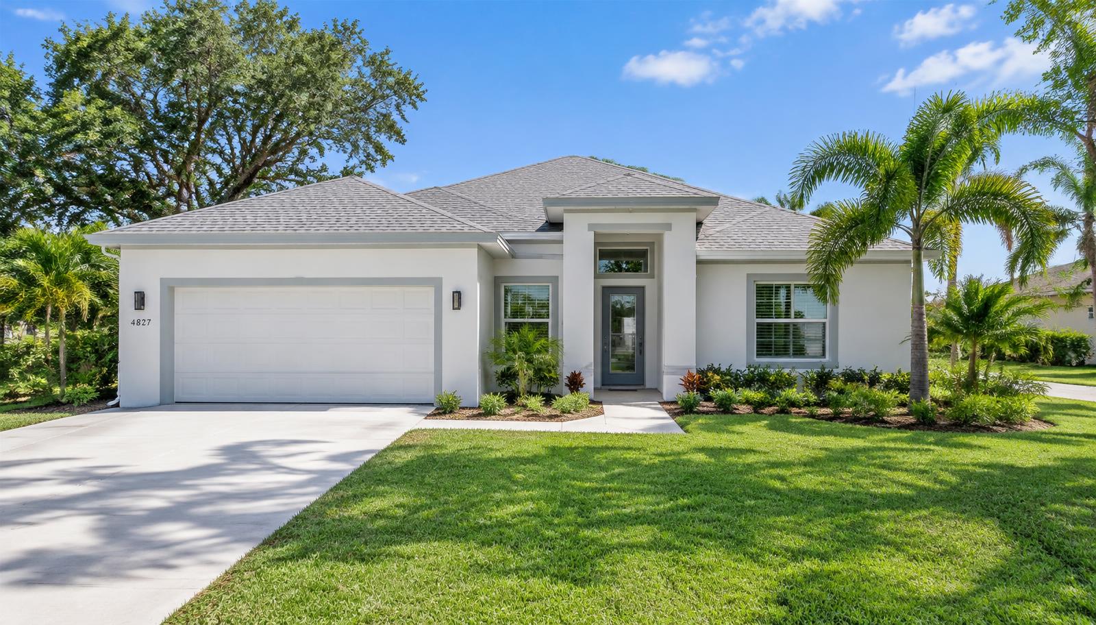 Newly built single-story home with a green lawn